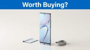 A slim smartphone standing upright on a clean surface with a charging cable.